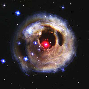 The Galactic cluster Abell 2218, with a tiny red galaxy 13.4 billion l.y. distant shown in the inset.
